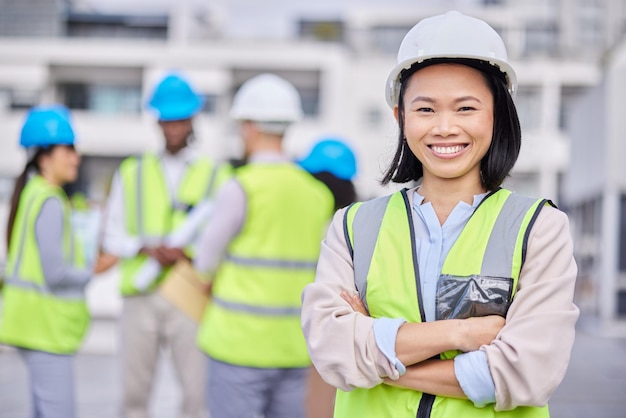 Portrait Asian woman arms crossed and engineer outdoor building and inspector with smile new project and deadline Face female employee and manager with hard hat vest and construction inspector