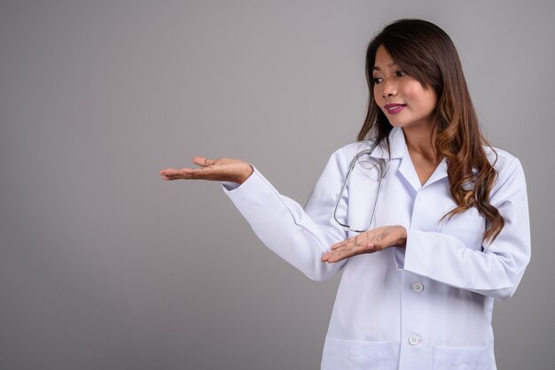 Portrait of Asian woman doctor with wavy hair