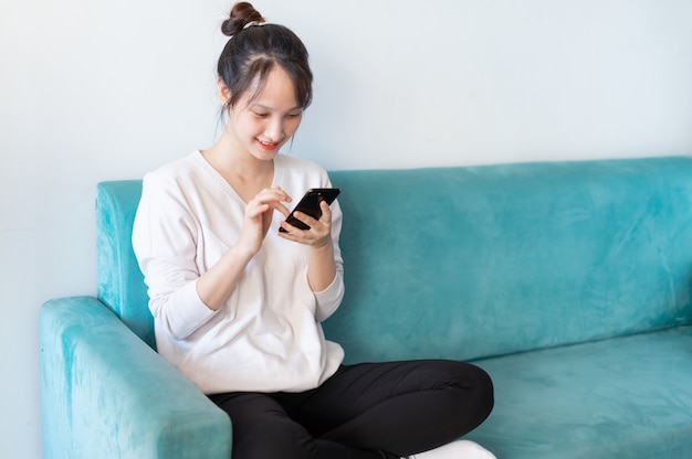 Portrait of asian woman at home, on sofa