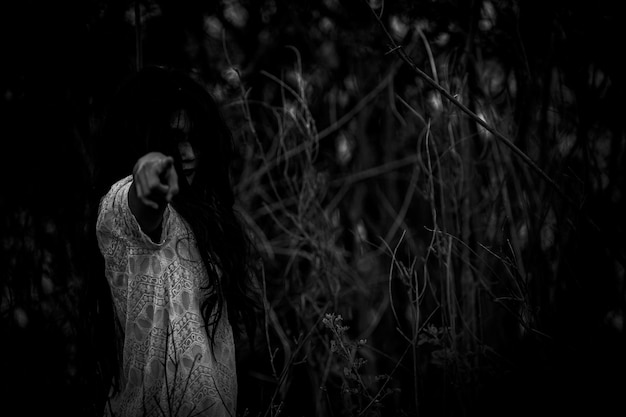 Photo portrait of asian woman make up ghost face at the swamphorror in water scenescary at riverhalloween posterthailand people