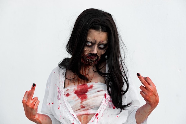 Portrait of asian woman make up ghost face with blood on white backgroundHorror sceneScary backgroundHalloween posterThailand people