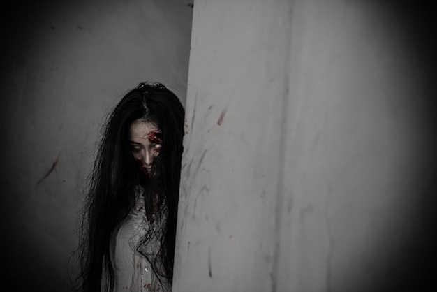 Portrait of asian woman make up ghost faceHorror sceneScary backgroundHalloween poster