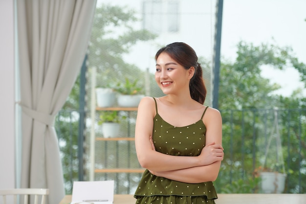 Portrait of asian woman standing with crossed arms in living room