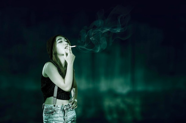 Photo portrait of asian woman vaping or smoking