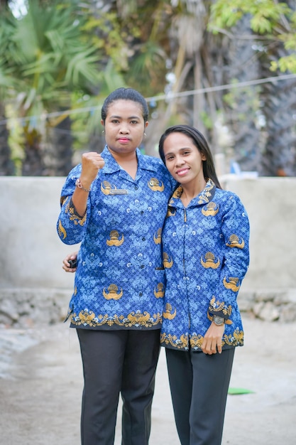 portrait of asian woman wearing batik korpri. indonesian traditional worker uniform