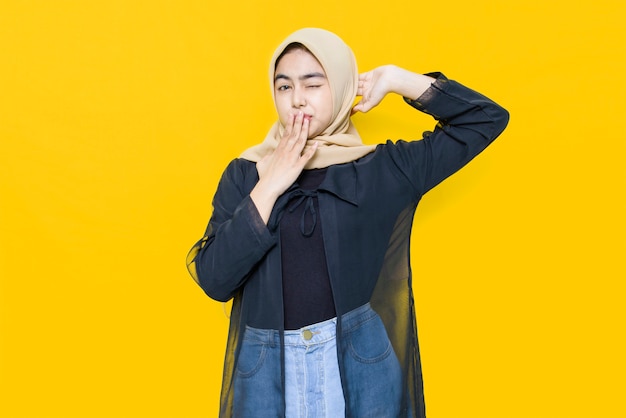 Photo portrait of asian woman with cute face on yellow wall