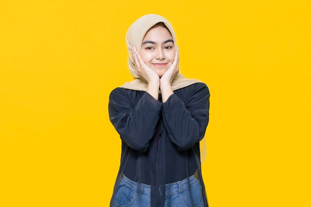 Portrait of Asian woman with cute face on yellow wall