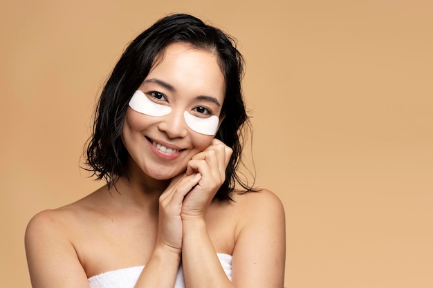 Portrait of asian woman with eye patches looking to the camera