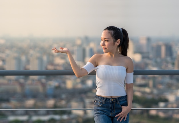 Portrait of Asian Yong woman in sexy fashion suit standing on the rooftop