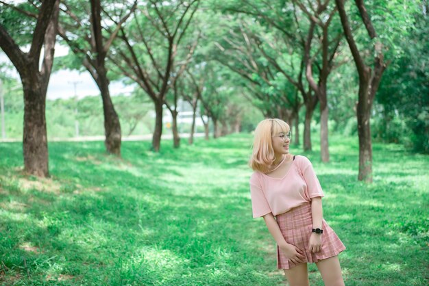 Portrait of asian young girl at tunnel treesBeautiful thai woman take a photo outdoorshappy woman conceptshe feeling fresh air