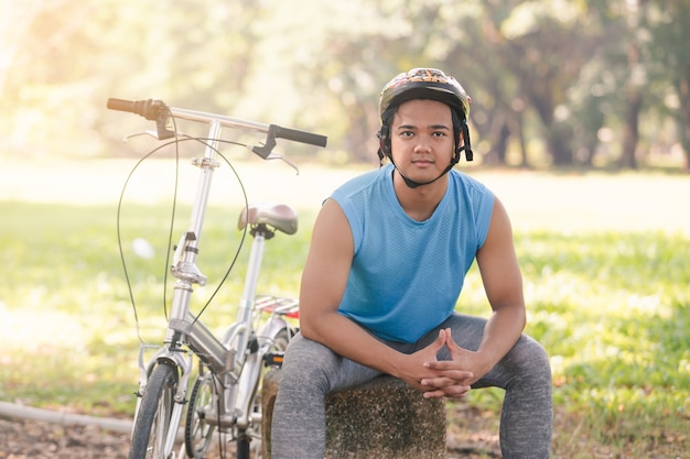 Portrait asian young man riding bicycle in the park ,Man lifestyle concept sport