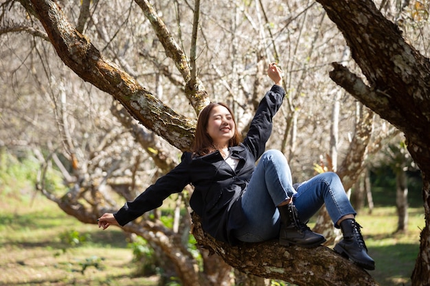 Portrait of Asian young woman enjoying plum blossom garden in the spring.