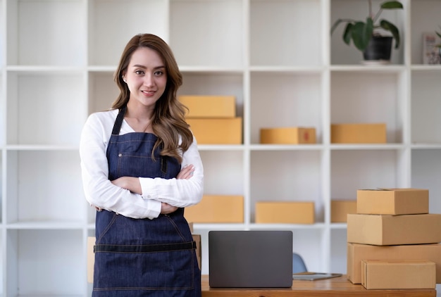 Portrait of Asian young woman SME working with a box at home the workplacestartup small business owner small business entrepreneur SME or freelance business online and delivery concept