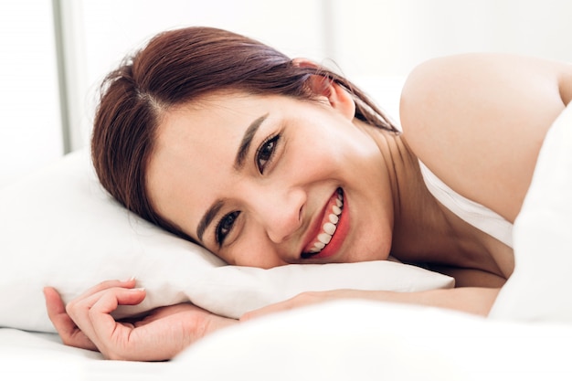 Portrait of asiann woman enjoy and relax on the bed in bedroom at home.asiann beauty
