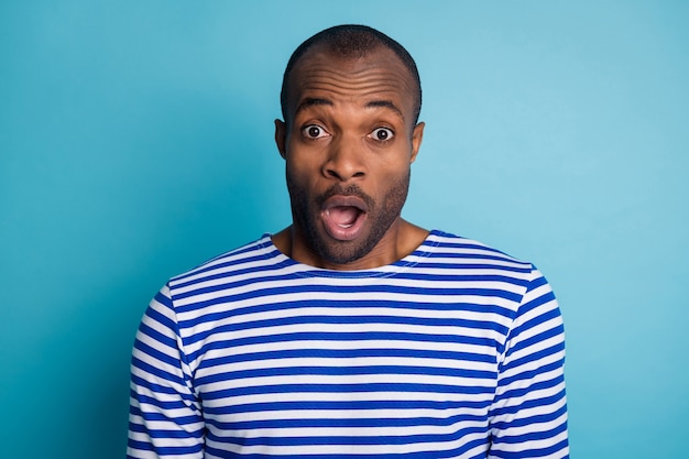 Portrait of astonished afro american guy impressed scream wear nautical vest