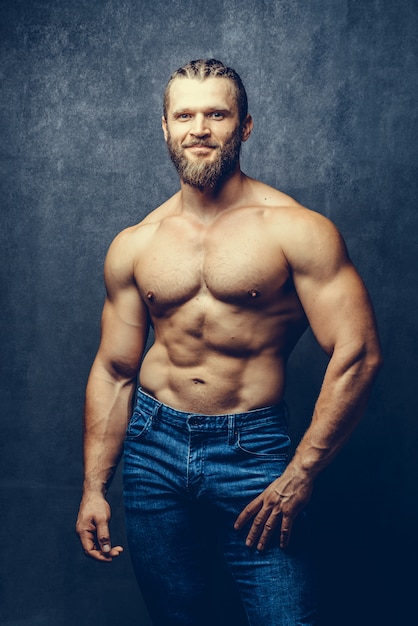 Portrait of a athleltic muscular bearded man posing