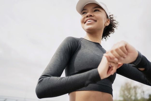 Portrait of an athlete looking over her shoulder smiling happy with the result of training