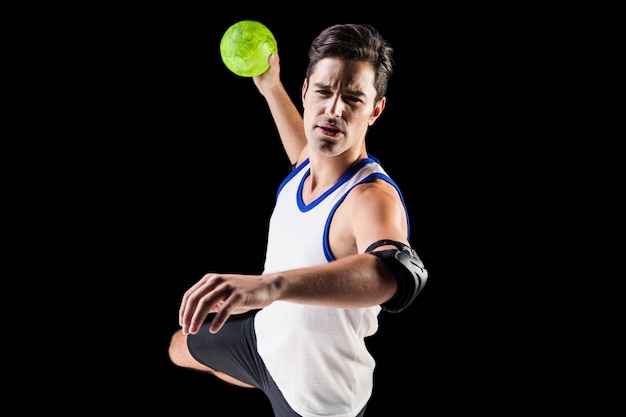 Portrait of athlete man throwing a ball 