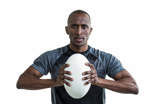 Portrait of athlete pressing rugby ball