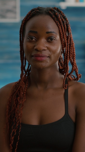 Portrait of athlete with black skin while siting on aerobics ball