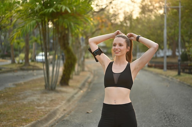 Portrait of athletic young woman resting after workout routine outdoor Fitness training and healthy lifestyle concept