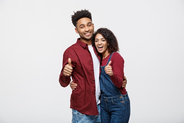 Portrait of attractive African american couple showing thumb up