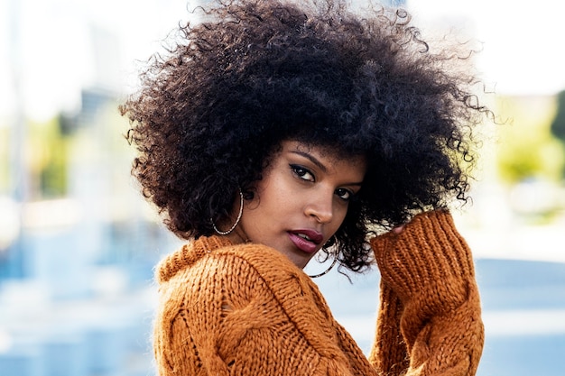 Portrait of attractive afro woman in the street. Hair style concept