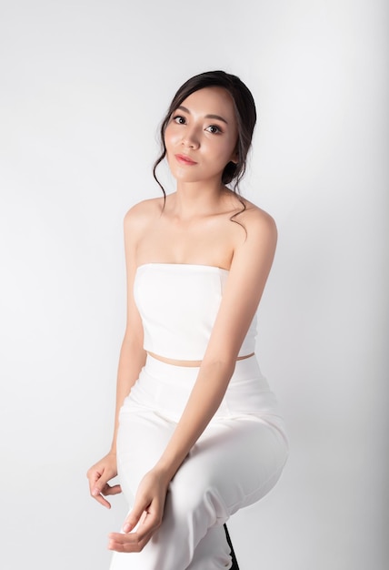 Portrait of Attractive Beauty Asian Women in Fashion Posing with Smiling Face Wearing White Dress on White Background for Cosmetic or Health Media