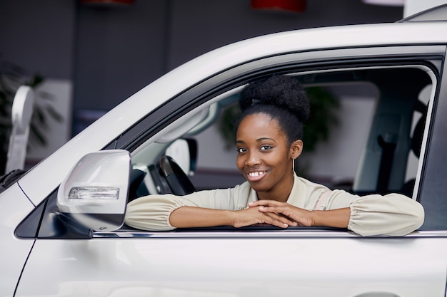 Portrait of attractive black lady in car