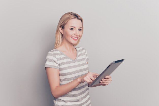 Portrait of an attractive blonde woman using tablet