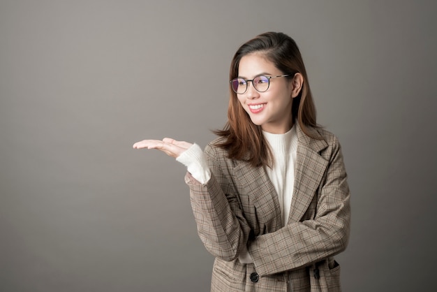 Portrait of Attractive business woman in studio grey background 