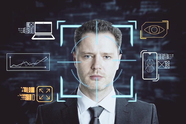 portrait of attractive businessman with creative face recognition control hologram on dark background technology and smart tech concept double exposure