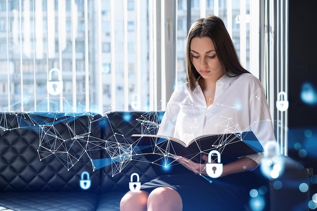 Portrait of attractive businesswoman working with documents and thinking how to protect clients confidential information and cyber security IT hologram padlock icons over office background
