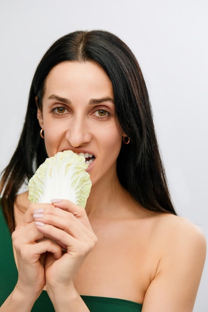 Portrait of attractive caucasian smiling woman isolated on white studio shot eating salat