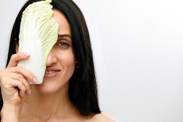 Portrait of attractive caucasian smiling woman isolated on white studio shot eating salat