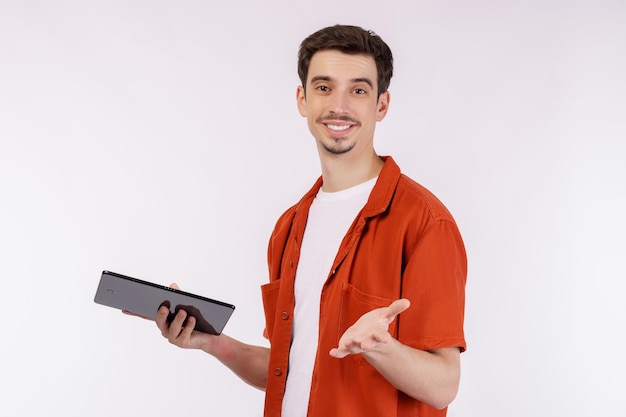 Portrait of attractive cheerful man using device app searching web isolated over white color background