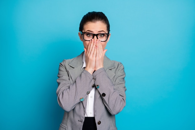 Portrait of attractive classy cheery shy modest businesslady closing face isolated over bright blue color background