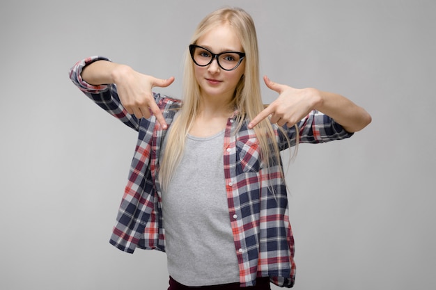 Portrait of attractive confident sweet adorable blonde teenager girl in checkered clothes 