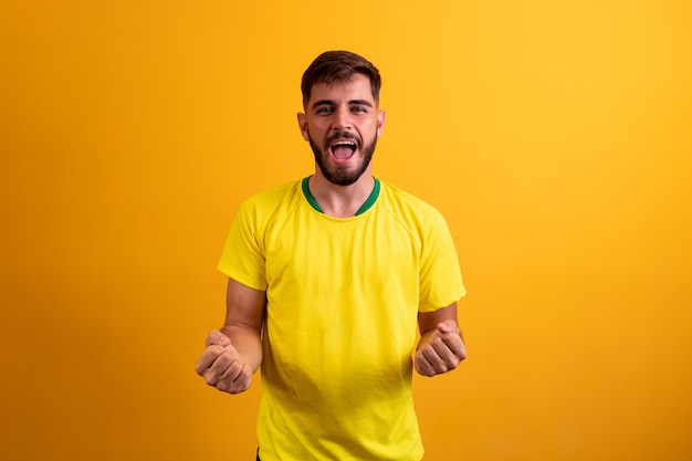 Portrait of attractive lucky cheerful bearded guy celebrating best luck isolated over bright yellow color background