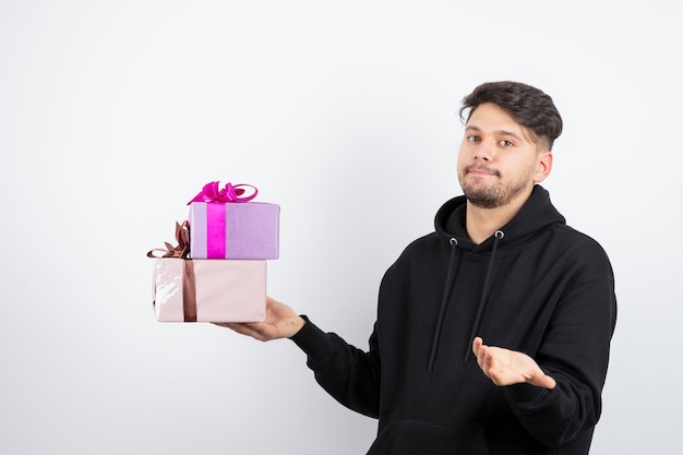 Portrait of an attractive man holding two present boxes 