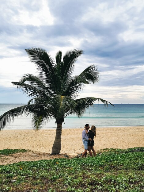 Portrait of an attractive man with a woman in the beach