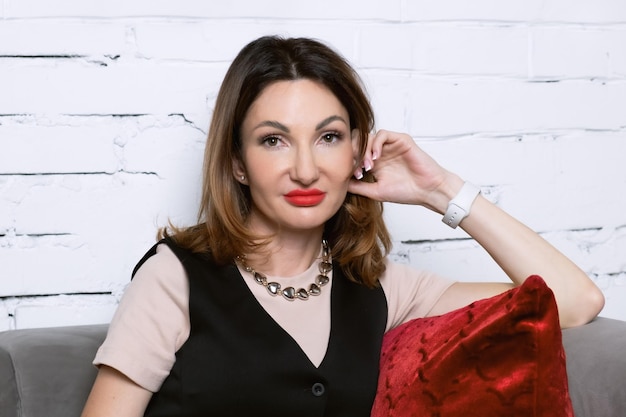 Portrait of an attractive middle aged woman with bright red lipstick Beautiful woman smiling and looking at the camera