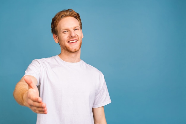 portrait of attractive red-haired caucasian young man wearing casua