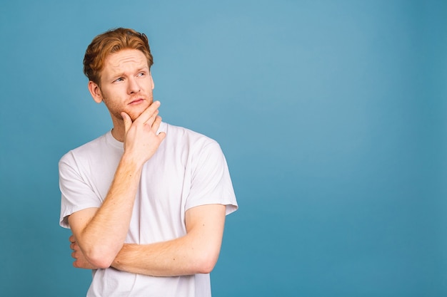 portrait of attractive red-haired caucasian young man wearing casual