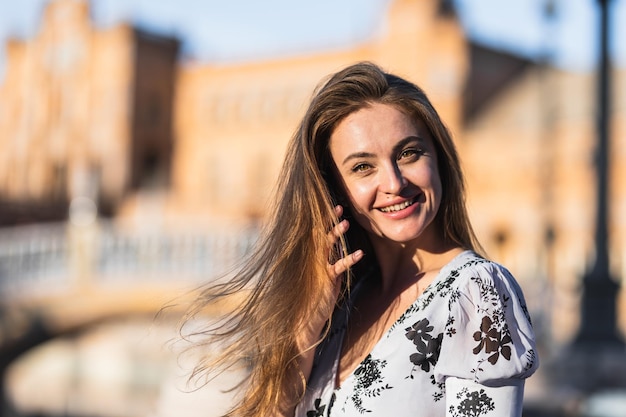 Portrait of an attractive smiling woman talking on her smartphone