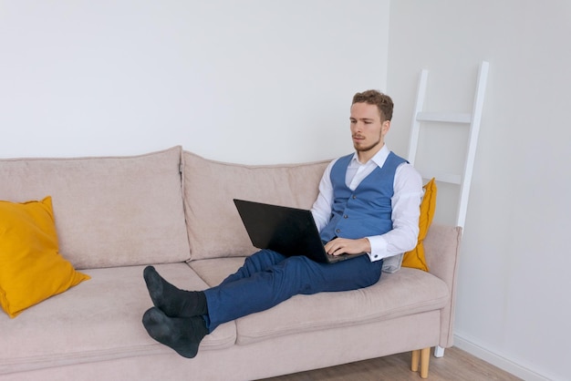 Portrait attractive smiling young bearded man wearing business suit sitting