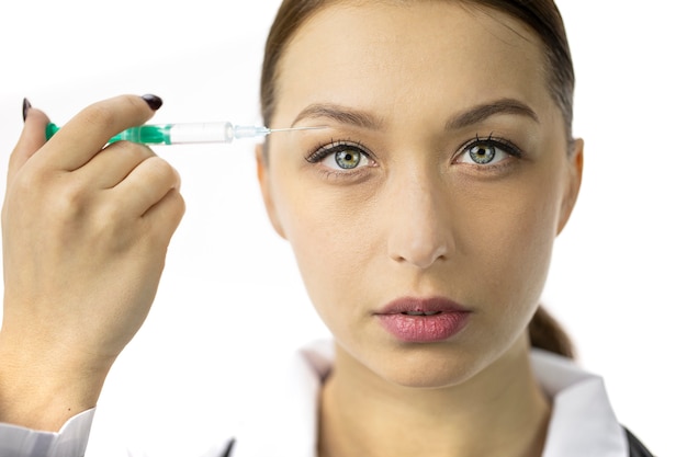 Portrait of attractive woman filling wrinkles over the upper eyelid from syringe