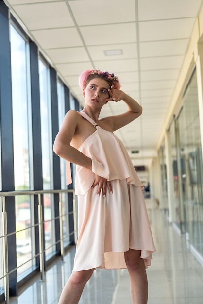 Portrait of attractive woman with hairstyle and makeup near window