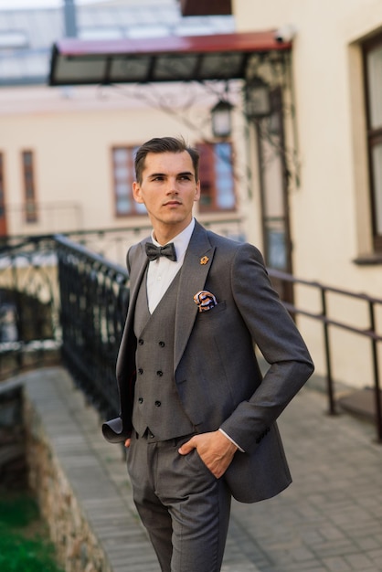 Portrait of an attractive young businessman in urban background wearing suit and a tie.