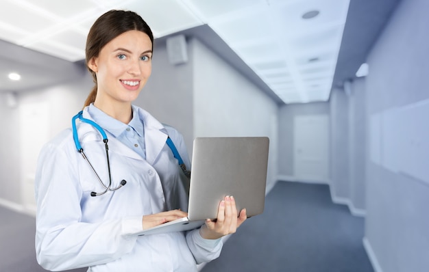 Portrait of an attractive young female doctor in white coat